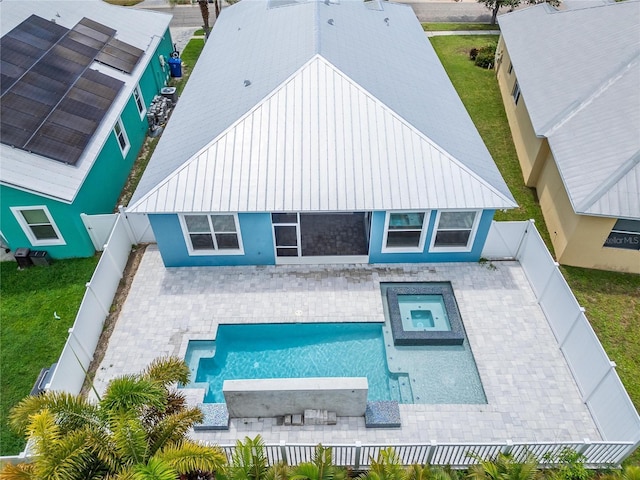 back of property with a patio area, a fenced backyard, and a pool with connected hot tub