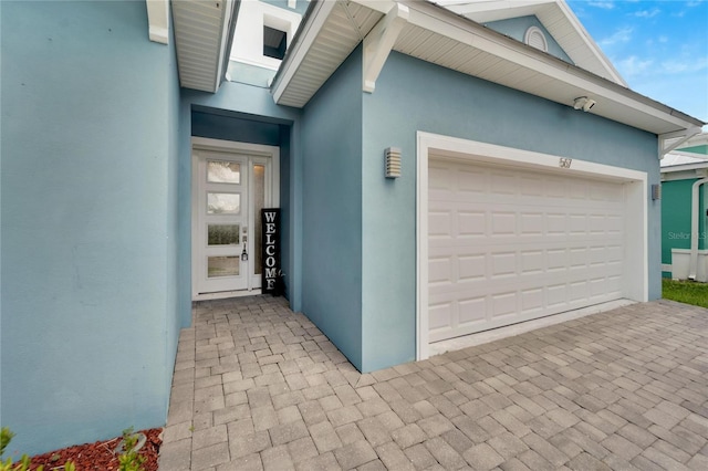 garage with decorative driveway