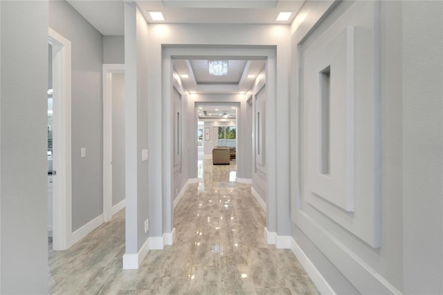 hall featuring light wood finished floors and baseboards