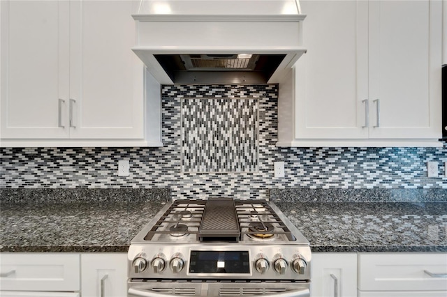 kitchen with gas range, white cabinetry, and dark stone countertops