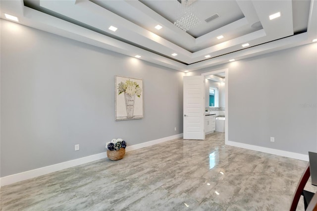 unfurnished bedroom with a tray ceiling, ensuite bath, visible vents, and baseboards