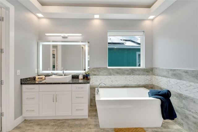 full bathroom with a freestanding tub and vanity