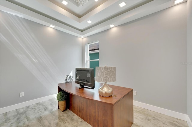 home office featuring a tray ceiling and baseboards