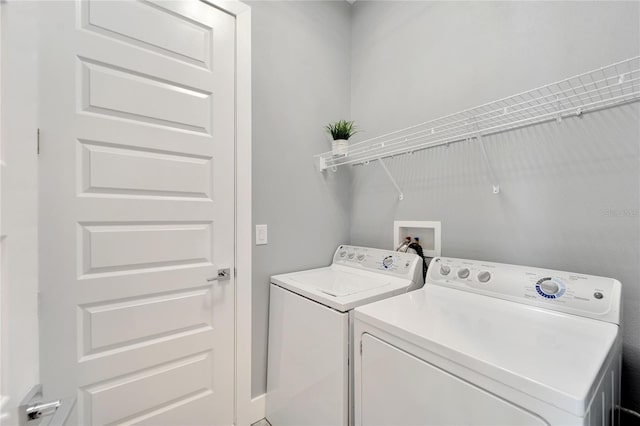 clothes washing area featuring laundry area and separate washer and dryer