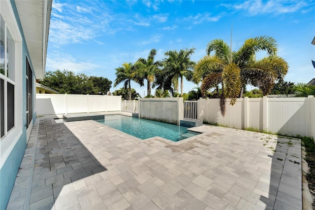 view of swimming pool with a fenced backyard, a fenced in pool, and a patio