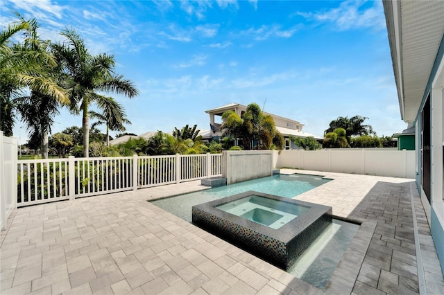 view of swimming pool featuring an in ground hot tub, a patio, and a fenced backyard