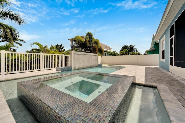 view of swimming pool featuring a fenced backyard, a patio, and an in ground hot tub