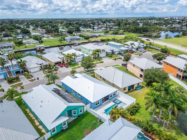 birds eye view of property with a water view and a residential view