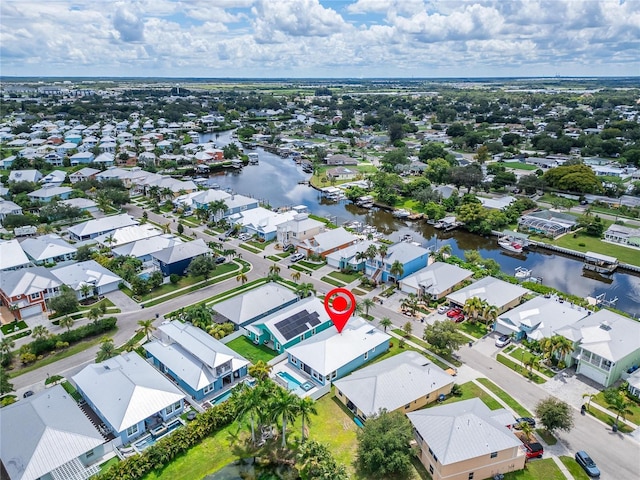 drone / aerial view featuring a residential view and a water view