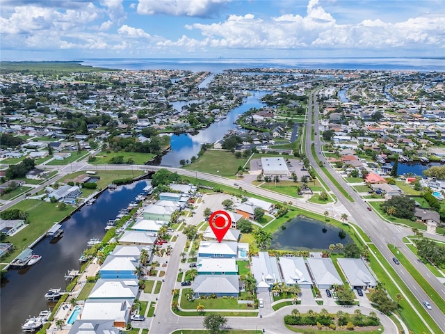 birds eye view of property featuring a water view and a residential view