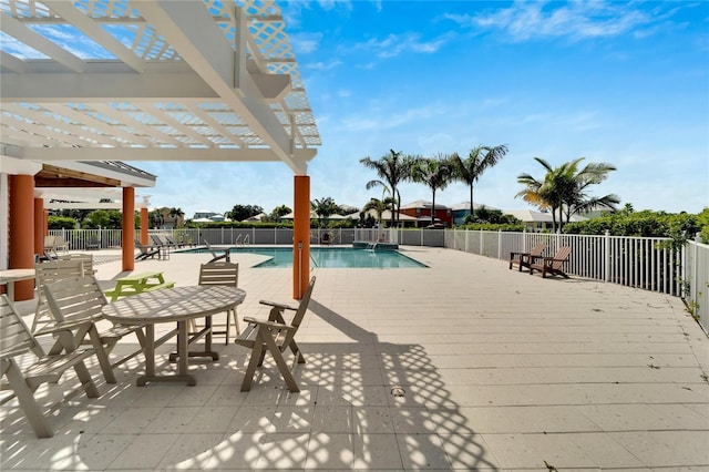 pool with a patio, fence, and a pergola