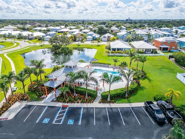 drone / aerial view featuring a water view and a residential view