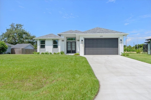 view of front of house featuring a garage, concrete driveway, and a front lawn