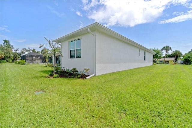 view of property exterior with a lawn and stucco siding