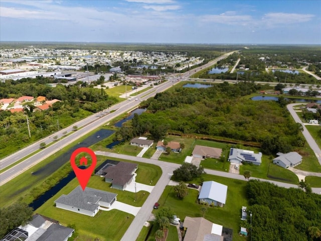 birds eye view of property with a water view and a residential view