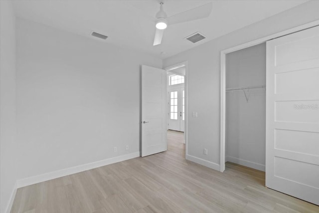 unfurnished bedroom featuring light wood-style floors, visible vents, and baseboards