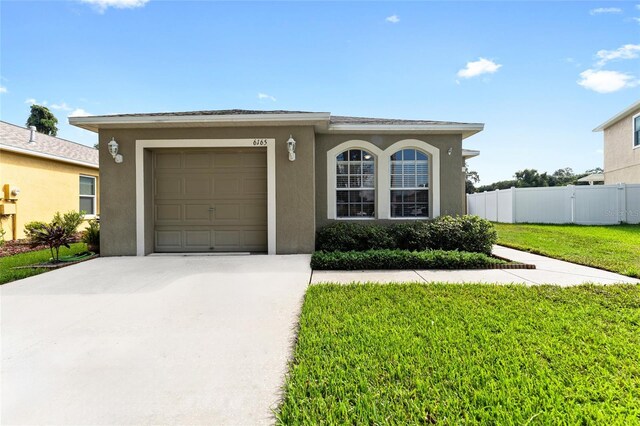 view of front of house featuring a front yard and a garage