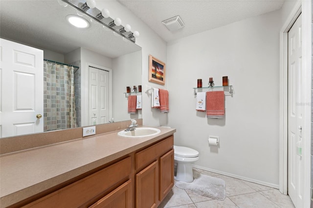 bathroom with a textured ceiling, toilet, vanity, visible vents, and a closet