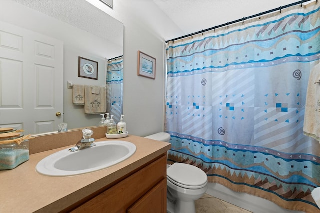 full bath featuring tile patterned flooring, vanity, toilet, and a textured ceiling