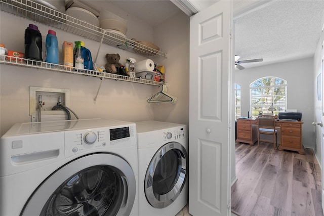 washroom featuring washing machine and dryer, ceiling fan, a textured ceiling, wood finished floors, and laundry area