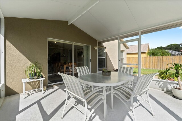 sunroom with lofted ceiling with beams