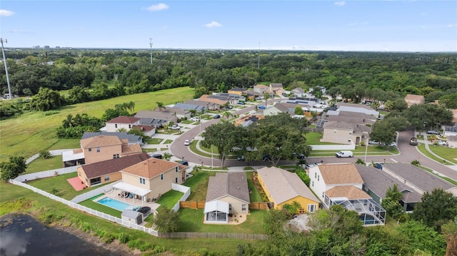 drone / aerial view with a residential view and a view of trees