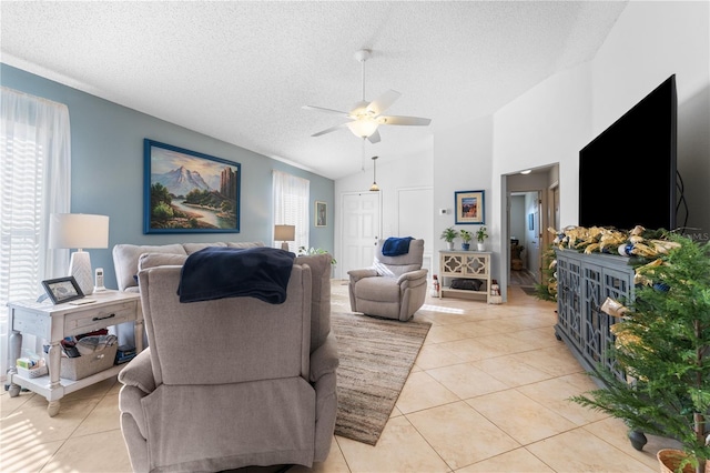 living room with ceiling fan, light tile patterned flooring, a textured ceiling, and high vaulted ceiling