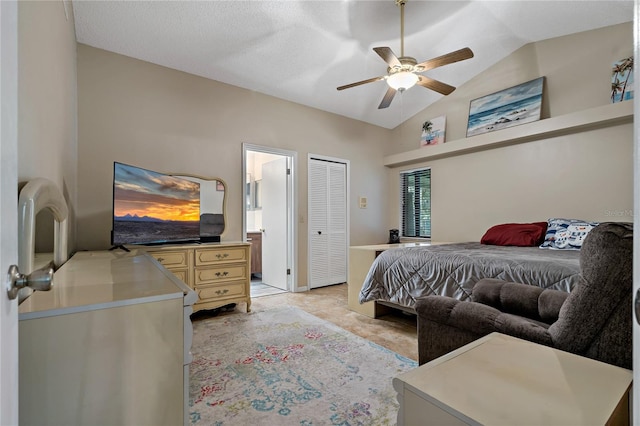 tiled bedroom with lofted ceiling, ceiling fan, and connected bathroom