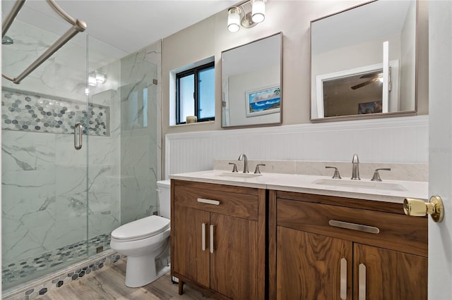 bathroom featuring toilet, an enclosed shower, vanity, ceiling fan, and hardwood / wood-style flooring