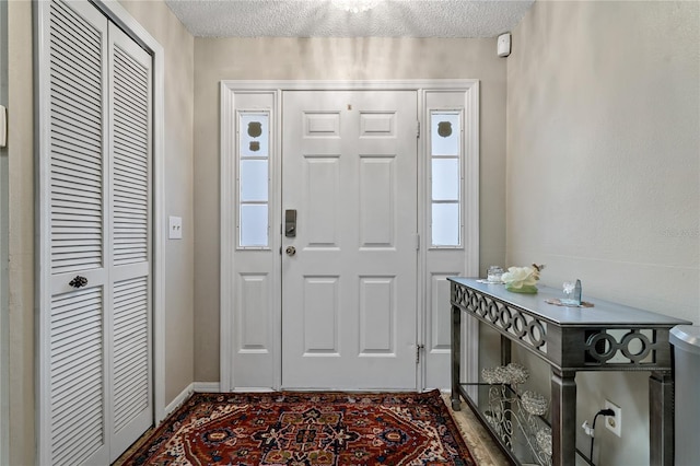 foyer with a textured ceiling