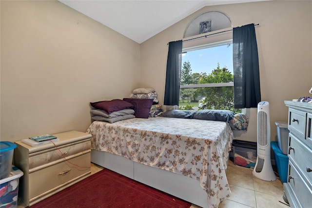 tiled bedroom featuring vaulted ceiling