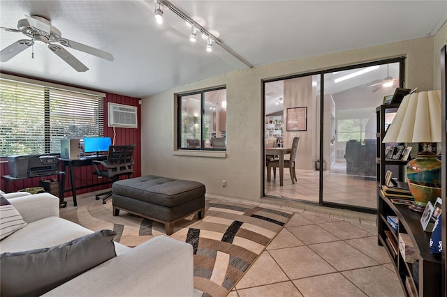 living room featuring rail lighting, a wall unit AC, light tile patterned floors, and ceiling fan