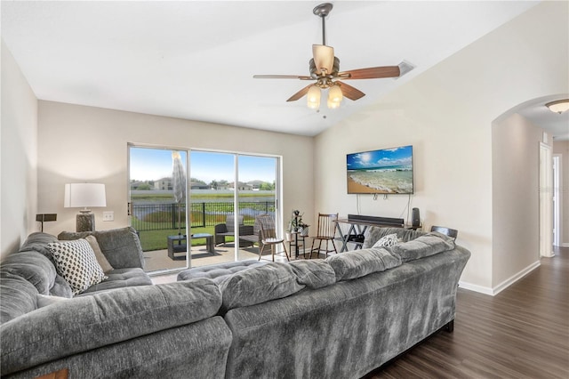 living room featuring dark wood-type flooring, vaulted ceiling, and ceiling fan