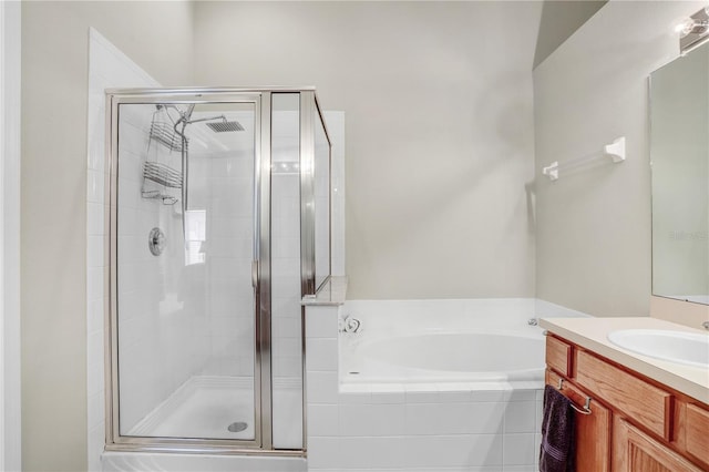 bathroom with vanity and separate shower and tub