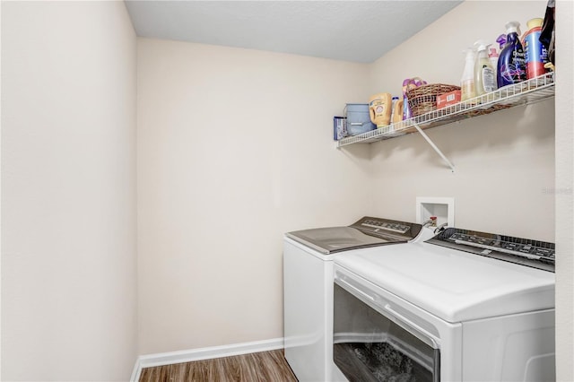 laundry room featuring dark wood-type flooring and independent washer and dryer