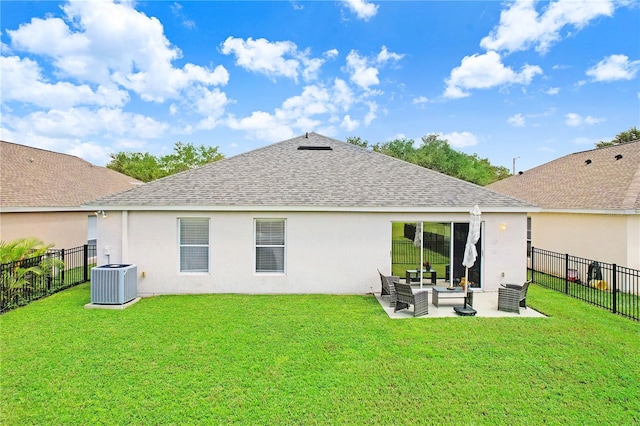 rear view of property with a lawn, a patio, and central AC