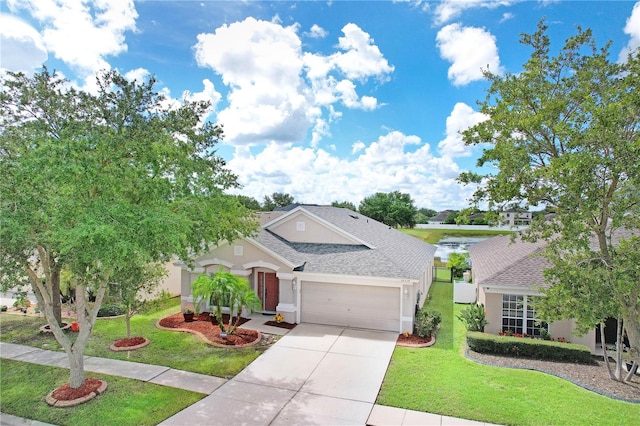 view of front of property with a garage and a front lawn