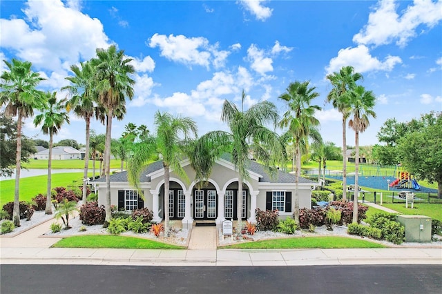 view of front of home featuring a playground and a front yard