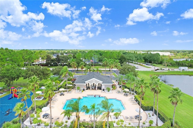 view of pool with a playground, a patio area, and a water view