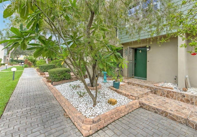 exterior space featuring a lawn and stucco siding