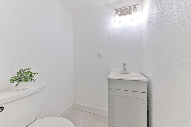 bathroom with vanity, toilet, and tile patterned flooring