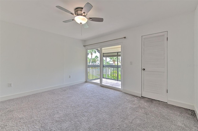 spare room featuring ceiling fan, carpet floors, and baseboards