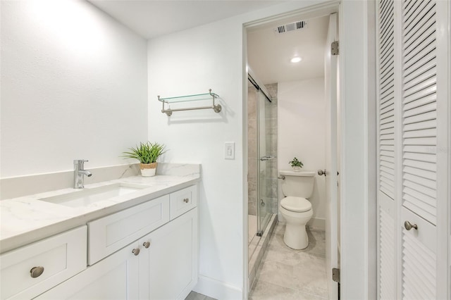 bathroom featuring an enclosed shower, tile patterned flooring, toilet, and vanity