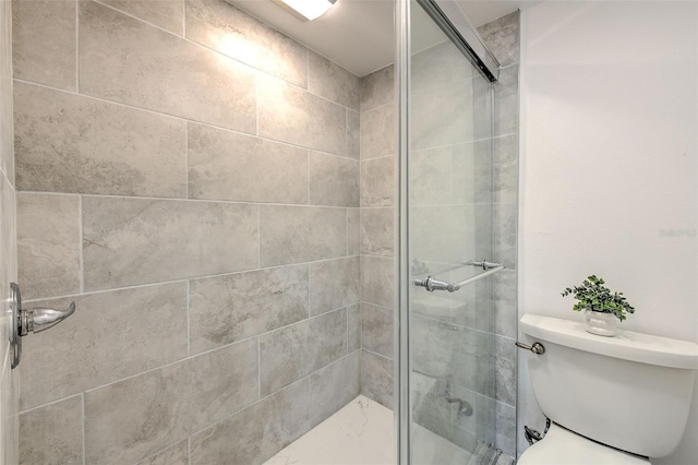 bathroom with toilet and walk in shower