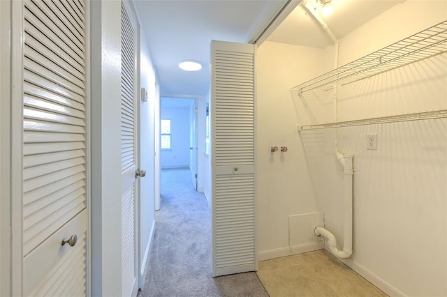 laundry room with light carpet