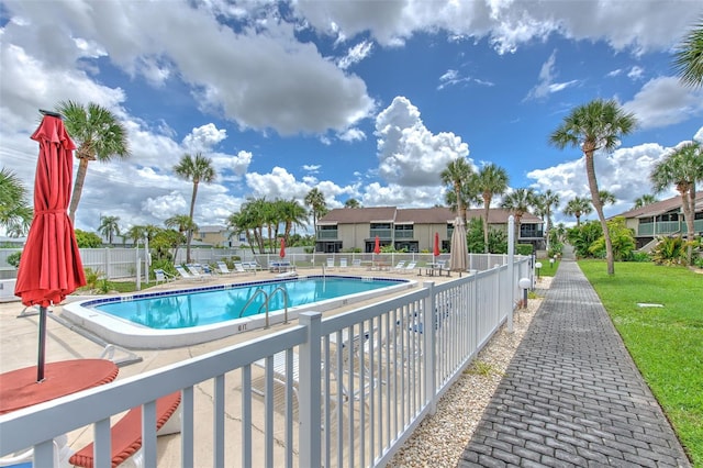 view of pool featuring a yard and a patio