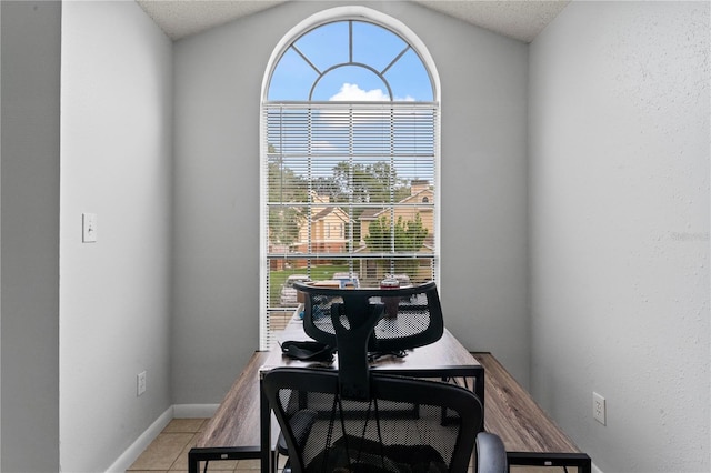 dining area featuring plenty of natural light, light tile patterned flooring, and baseboards