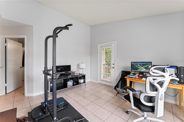 office area with light tile patterned floors, vaulted ceiling, and baseboards