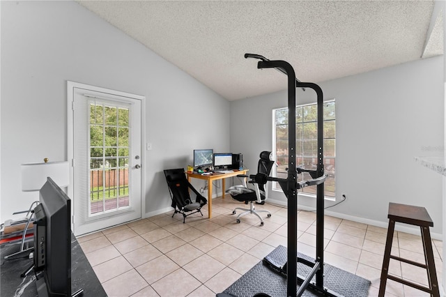 tiled office space featuring vaulted ceiling, a textured ceiling, and baseboards