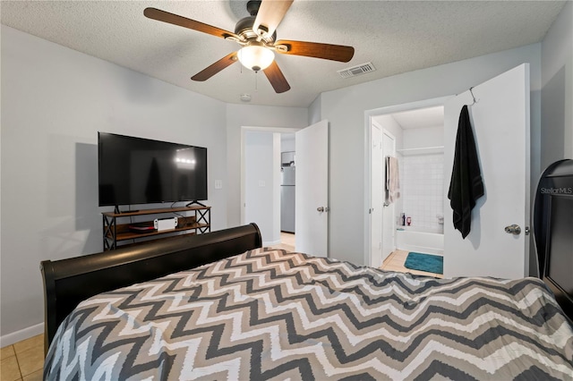 bedroom with light tile patterned floors, visible vents, a ceiling fan, a textured ceiling, and fridge